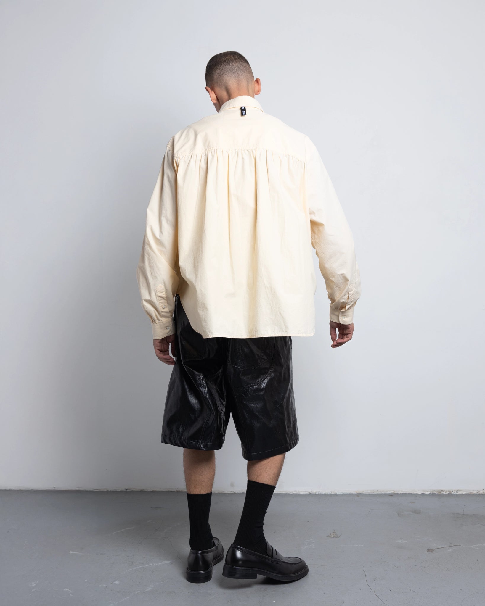 THE SHORT WORK CHAPS IN BLACK FAUX LEATHER