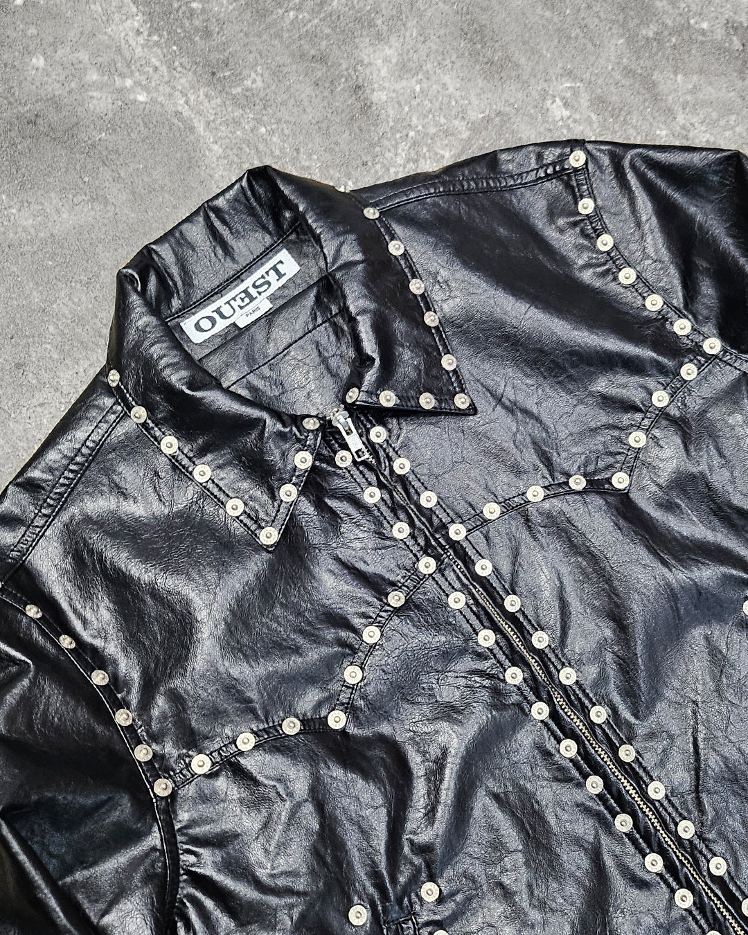 THE ZIPPED STUDDED JACKET IN BLACK FAUX LEATHER