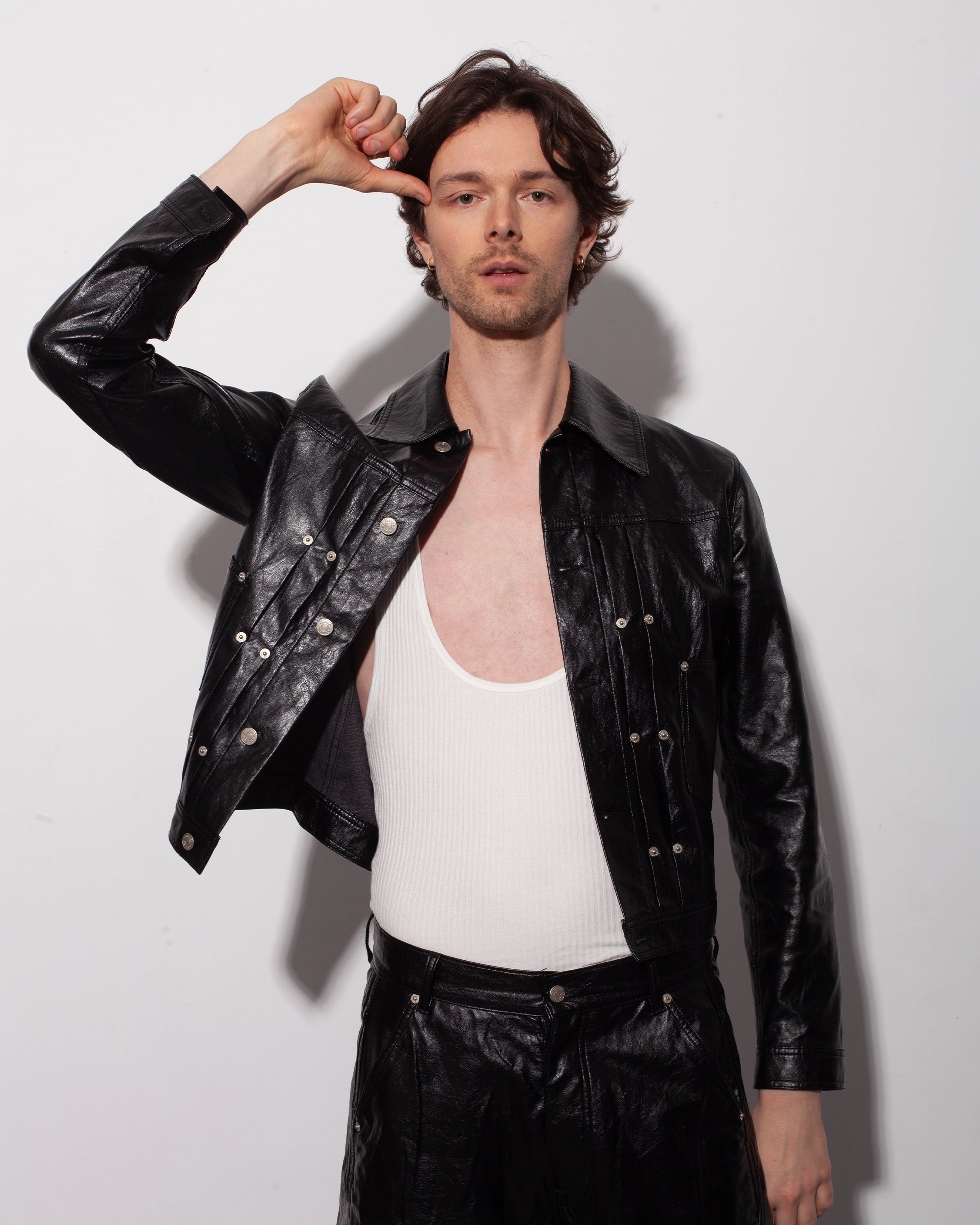 THE TRUCKER JACKET IN BLACK FAUX LEATHER